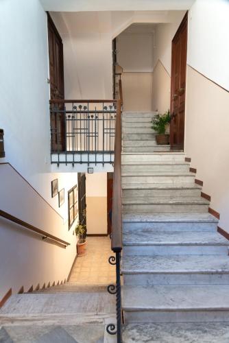 a staircase in an old building with concrete steps at Soggiorno in stile a Messina in Messina