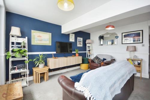 a living room with a bed and a couch at Dog friendly Beach Apartment in Broadstairs