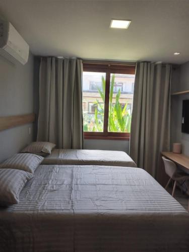 a bedroom with a large bed and a window at Village Viva Barra Grande in Marau