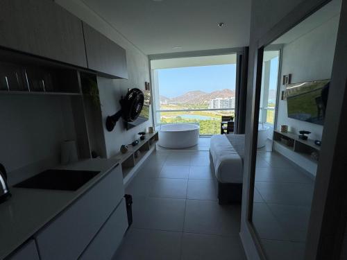 a bathroom with a sink and a tub in a room at Suite con Lujoso Jacuzzi, Piso 14 y vista al mar in Santa Marta