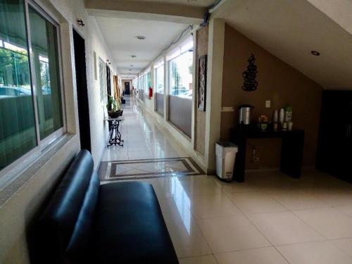 a hallway of a hospital with a couch in a room at Hotel Gya Boutique in Aguascalientes