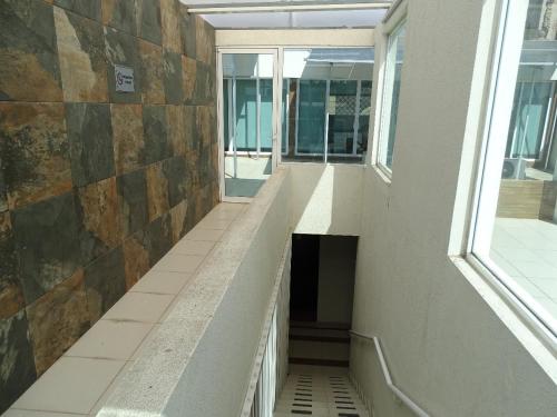 an empty hallway of a building with a window at Hotel Gya Boutique in Aguascalientes