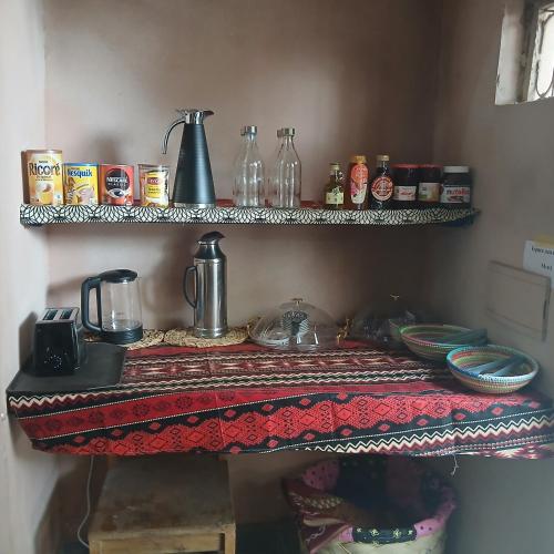 a kitchen with a table with a counter top with food at "Par 4 chemins" Atypical Stopover in Nouakchott