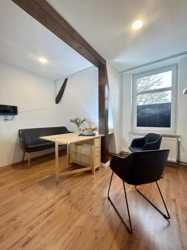 a living room with a table and chairs and a couch at Ferienwohnung Ost in Fehmarn