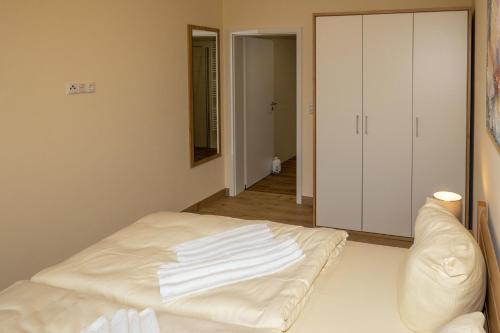 a room with a bed with white towels on it at Seewohnung "Riems" in Gützkow