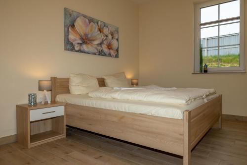 a bedroom with a bed and a window at Seewohnung "Riems" in Gützkow