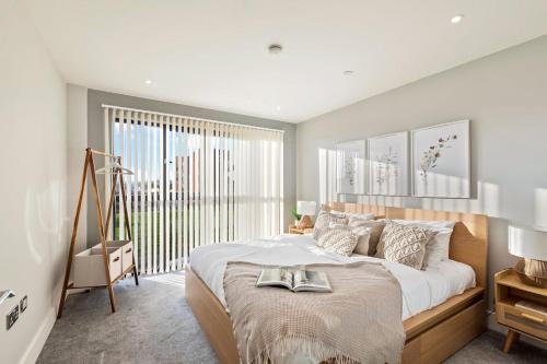 a bedroom with a large bed with two shoes on it at Beautiful Apartment in City Centre with Free Parking, Self-Check-In, Fast WiFi, Smart TV and Rooftop Terrace by Yoko Property in Leicester