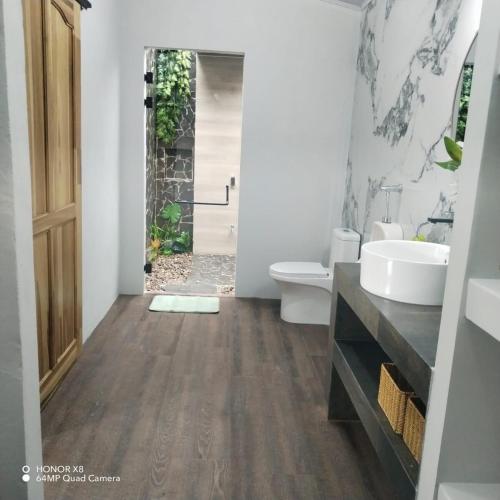 a bathroom with a toilet and a sink at Elegant studio in Fortuna