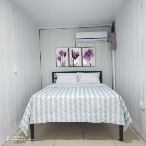 a bedroom with a bed with pink flowers on the wall at Elegant studio in Fortuna