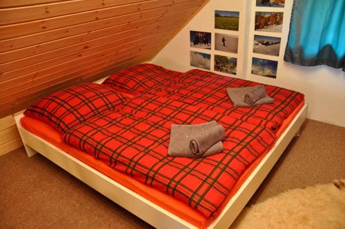 a bed with two pillows on it in a bedroom at Blockhaus Falkenstein in Grünbach