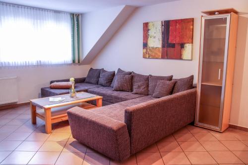 a living room with a couch and a table at Familienhof Brüning - Gartenblick in Meppen