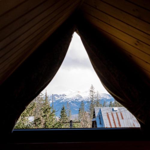 a view of a mountain from a window at Apartament Górski u Papierzy Sauna, Jacuzzi, SPA in Witów