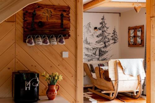 a room with a chair and shoes on the wall at Apartament Górski u Papierzy Sauna, Jacuzzi, SPA in Witów