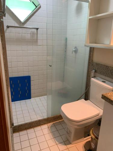a bathroom with a toilet and a glass shower at Marulhos Resort by HomeTemp in Porto De Galinhas