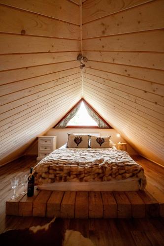 a bedroom with a bed in a wooden room at Apartament Górski u Papierzy Sauna, Jacuzzi, SPA in Witów