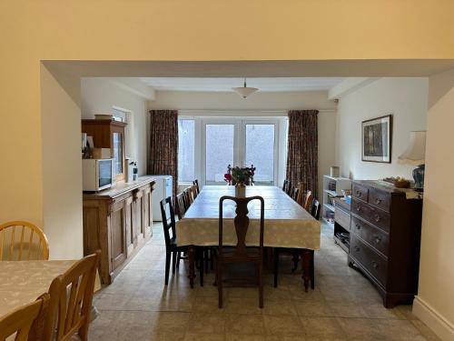 a kitchen and dining room with a table and chairs at Alt Na Craig in Portballintrae