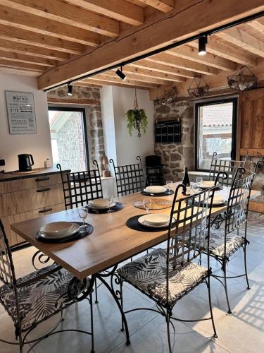 une salle à manger avec une table et des chaises en bois dans l'établissement La Petite Chavanne 4 étoiles, à Champdieu