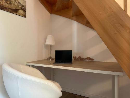 a room with a desk with a laptop and a chair at NicePlace4You in Klosterdorf