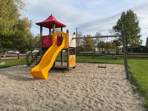 a playground with a slide in a park at NicePlace4You in Klosterdorf