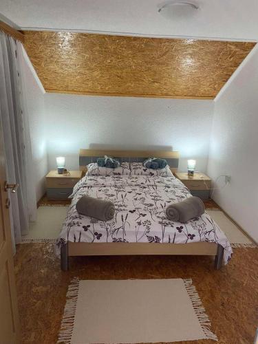 a bedroom with a large bed with two night stands at Villa Seferovka in Kulen Vakuf