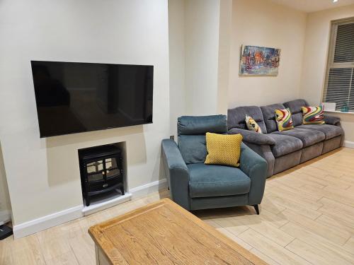 a living room with a couch and a fire place at Forthill Lodge in Enniskillen