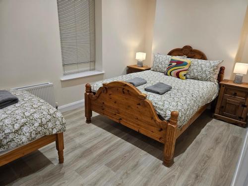 a bedroom with two beds and two night stands at Forthill Lodge in Enniskillen