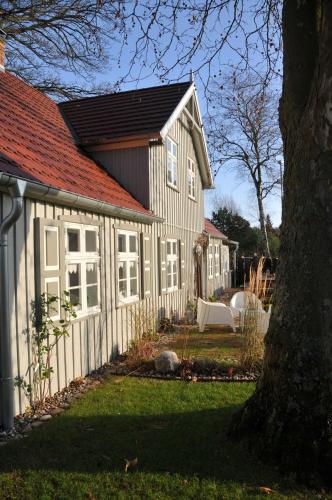 a white house with a red roof and a yard at Traumfängerhaus Engel in Prerow
