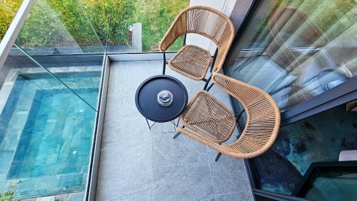a grill sitting on a chair next to a pool at Hotel Bucura in Călimăneşti
