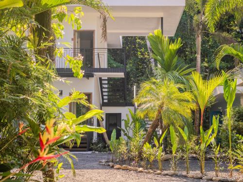 a house surrounded by trees and plants at Ojochal Gardens in Ojochal
