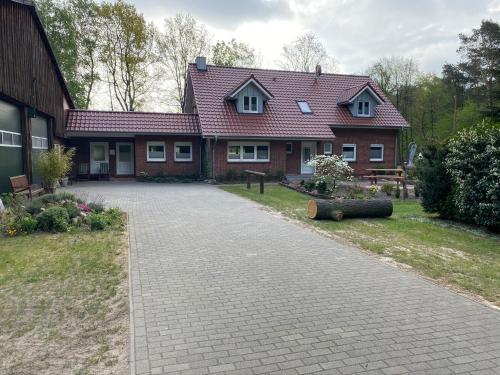 a house with a brick driveway in front of it at Ferienhof Thele Wohnung OG in Werlte