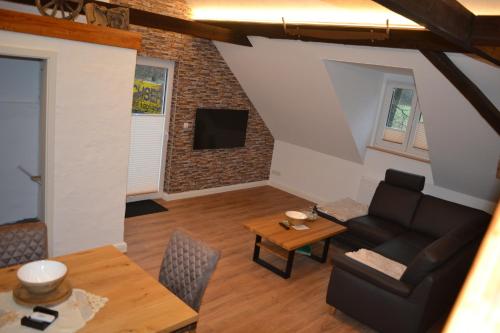 a living room with a couch and a table at Ferienhof Thele Wohnung OG in Werlte