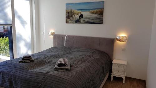 a bedroom with a bed with two towels on it at KüstenKind in Lauterbach