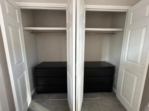 a walk in closet with black drawers at City Retreat 3 Bed House with King, Double and Single in Southampton