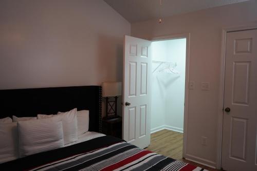 a bedroom with a bed and a door with a closet at Cozy Bartlett home with garage, fenced backyard in Memphis