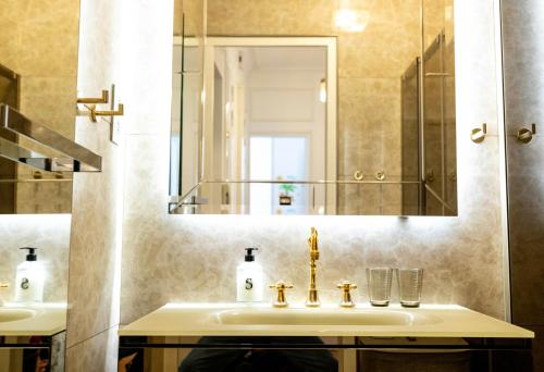 une salle de bain avec un lavabo et un miroir dans l'établissement Luxury Royal Suite, 118 square meters, notre dame, 3 bedrooms, à Paris