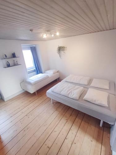 a bedroom with a bed and a window at Calm and cozy apartment with free parking in Hjørring