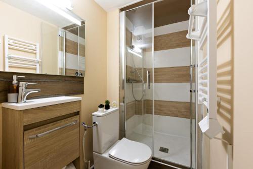 a bathroom with a toilet and a glass shower at Le Sublime-100m de la plage-Cozy-Refait à Neuf ! in Canet-en-Roussillon