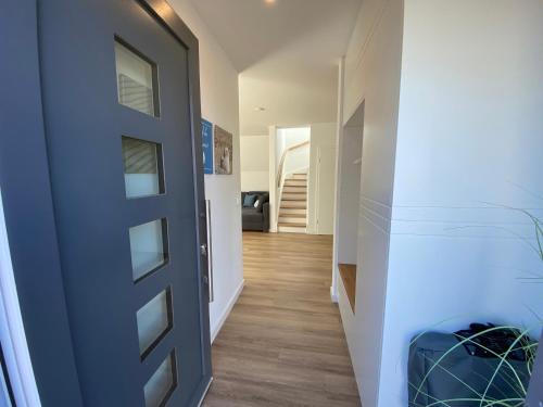 a hallway with a door leading to a stairway at Heimathafen Damp, Haus 9a in Damp