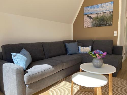 a living room with a couch and a table at Heimathafen Damp, Haus 9a in Damp