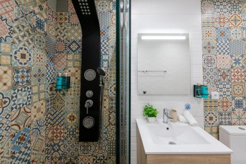 a bathroom with a sink and a mirror at Madeira House by Mathias in Funchal