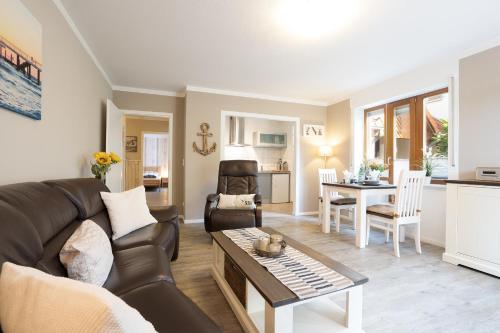 a living room with a couch and a table at Premium Quartier Solymar Pelzerhaken - ein kleiner Hund willkommen in Neustadt in Holstein