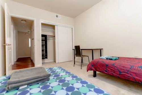 a bedroom with a bed and a table and a chair at Affordable Dorm Daly City in Daly City