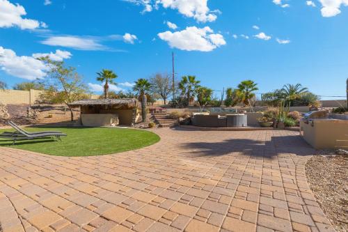 a patio with a picnic table and grass at Stunning 4br Retreat W Private Pool in Phoenix