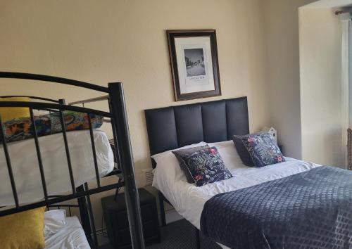 a bedroom with a bed next to a bunk bed at Station Guesthouse - key pad entry with parking in Lancaster