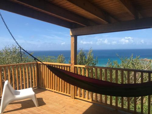 a hammock on a deck with a view of the ocean at Tres Bahias Culebra in Culebra