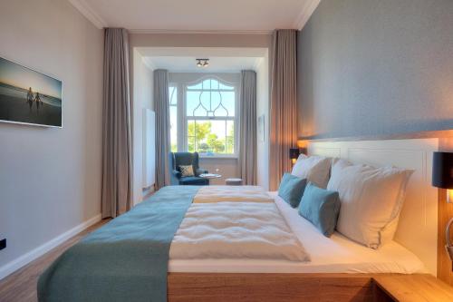 a bedroom with a large bed with a window at Villa Seeblick Schloonsee in Ahlbeck