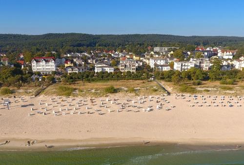an aerial view of a beach with umbrellas and buildings at Villa Seeblick Schloonsee in Ahlbeck