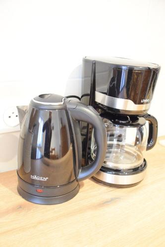 a toaster and a coffee maker on a table at Chambres d'hôtes "La Petite Vallée" in Rott