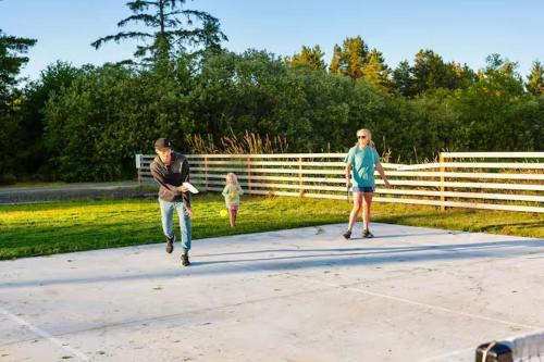 a man and a woman walking on a sidewalk with a child at Breakwater Resort in Grayland