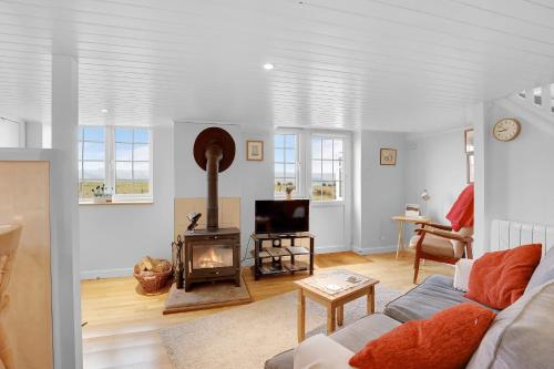 a living room with a couch and a fireplace at Hill House Hideaway - North East Escapes in Bardon Mill